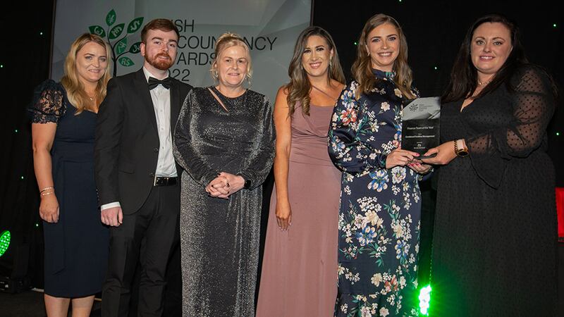 Cloe Stapleton, recruitment and business director, Osborne, presents the Finance Team of the Year award to the Combined Facilities Management team.