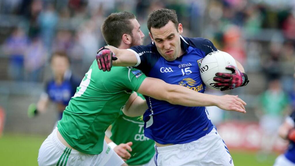 Fermanagh’s Brian Cox does best to tackle Eugene Keating of Cavan during the Ulster football championship quarter-final at Brewster Park. (Photograph: Morgan Treacy/Inpho)