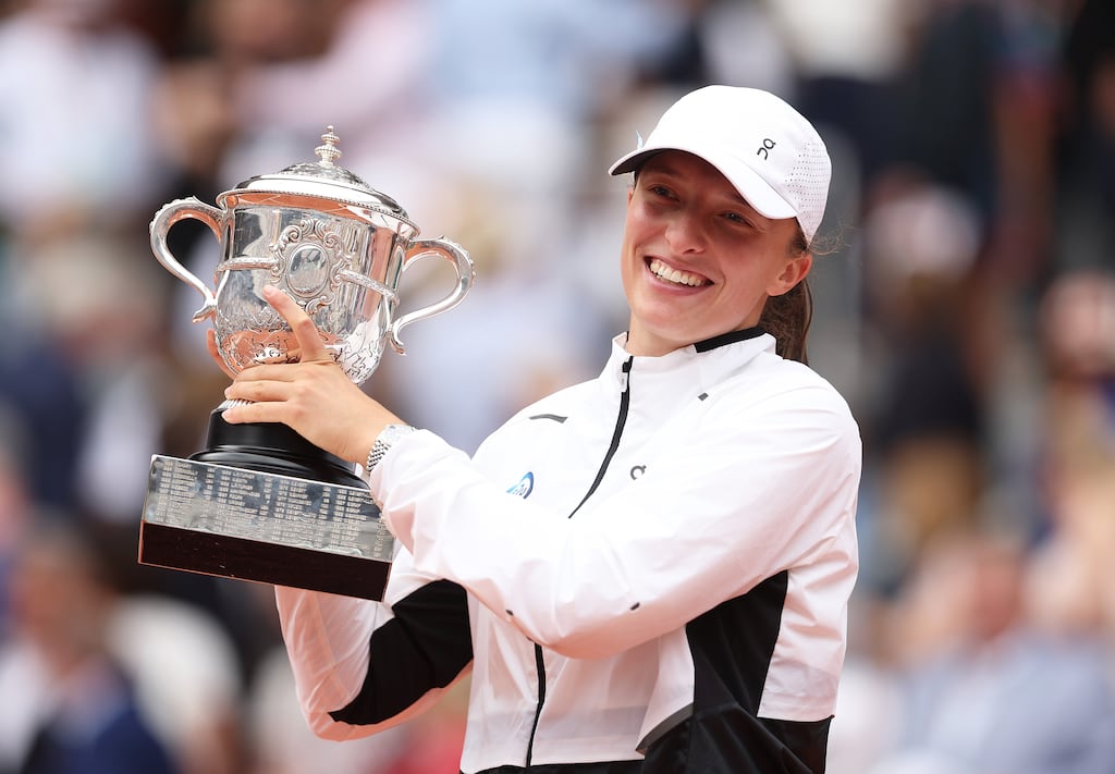 Iga Swiatek celebrates with her winners trophy after victory against Karolina Muchova in the French Open women's singles final at Roland Garros. Photograph: Julian Finney/Getty Images