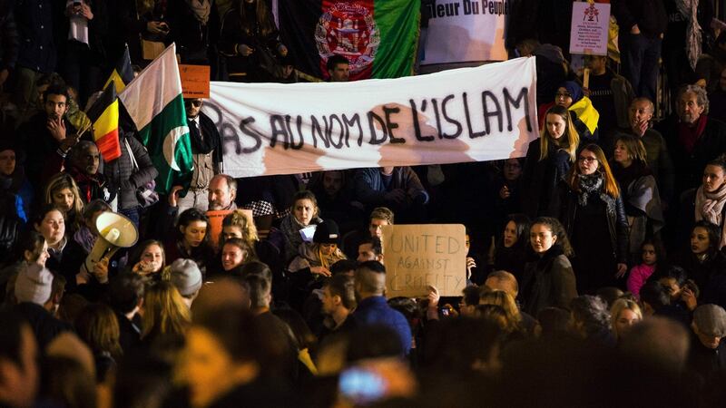 People hold a banner reading “not on behalf of Islam” as they gather to pay tribute to the victims of the Brussels terror attacks, on Place de la Bourse square in Brussels. Photograph: Laurie Dieffembacq/ AFP/Getty Images