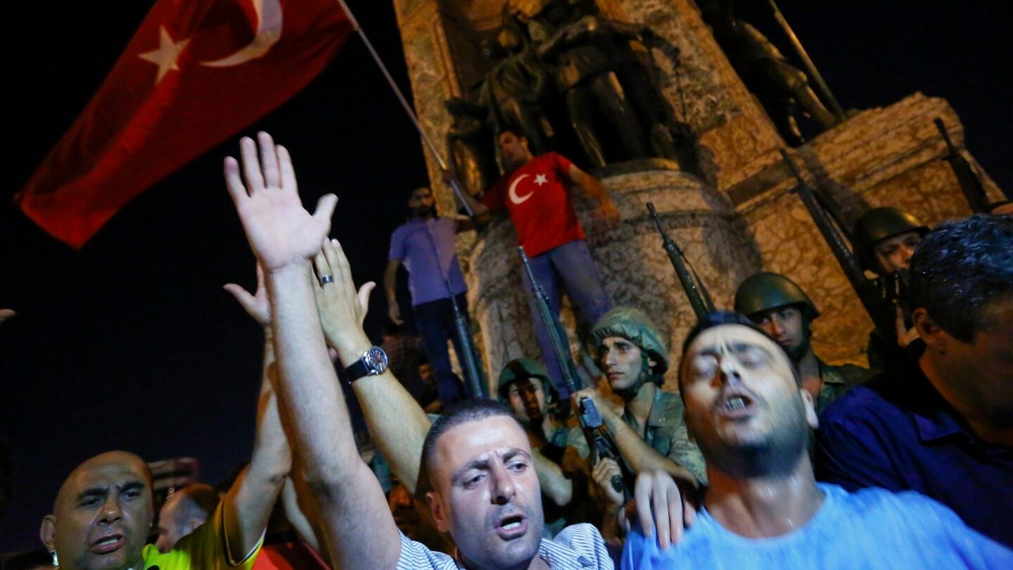People demonstrate in front of the Republic Monument at the Taksim Square in Istanbul, Turkey. Photograph: Murad Sezer/Reuters