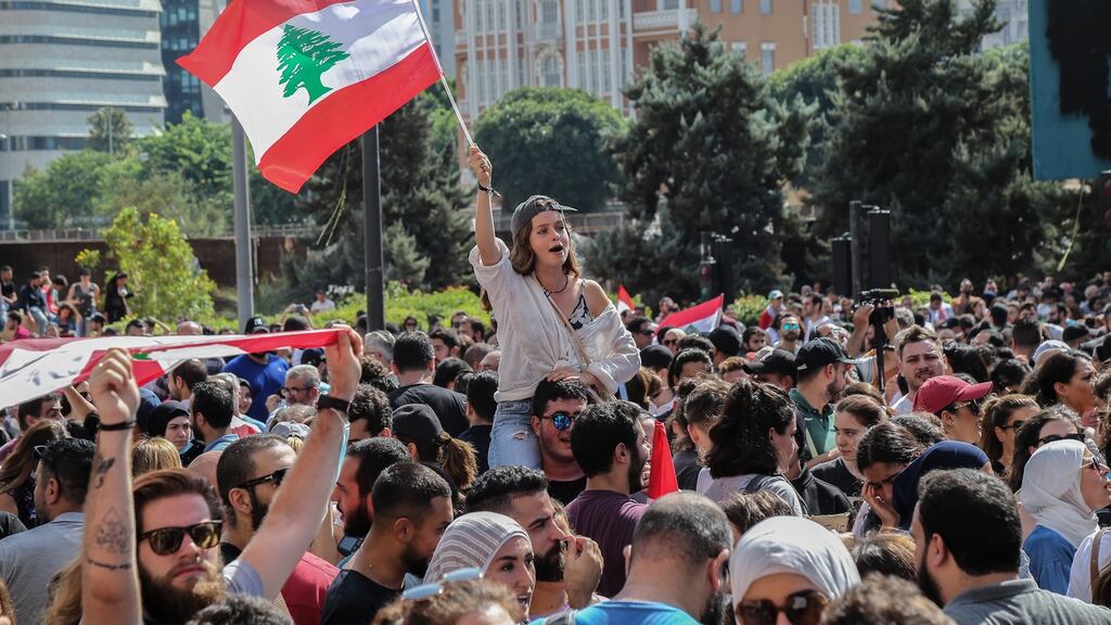 Protesters carry Lebanese flags and chant slogans in front the government palace during a protest in Beirut, Lebanon on Friday. Photograph: Nabil Mounzer/EPA