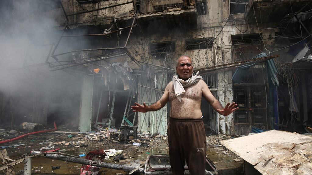 A man at the site of the car bomb attack in Baghdad on Thursday, which was claimed by Islamic State. Photograph: Ahmad al-Rubaye/AFP/Getty Images