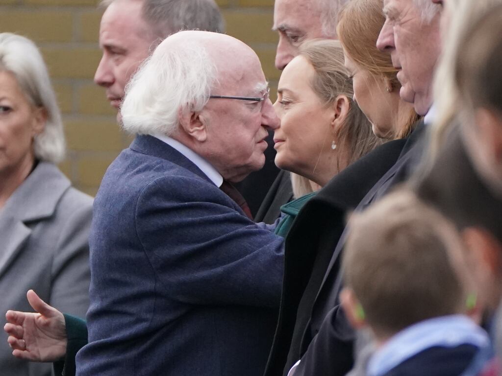 President Michael D Higgins hugs Tracey O'Flaherty, the widow of James O'Flaherty, as he leaves the funeral Mass for Mr O'Flaherty at St Mary's Church, Derrybeg. Photograph: PA Images