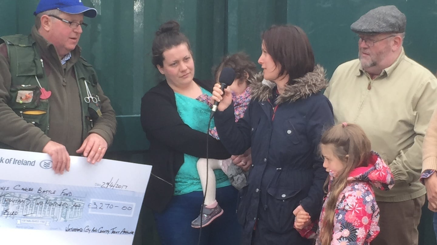 Michael Sheehan presenting the Nadine family with cheque towards cancer fund