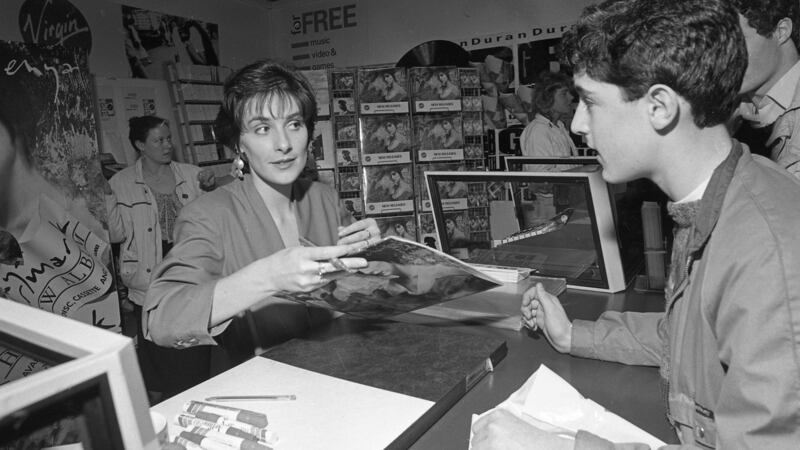 Enya signsign autographs in the Virgin megastore in Dublin in 1988. Photogrpah: Getty