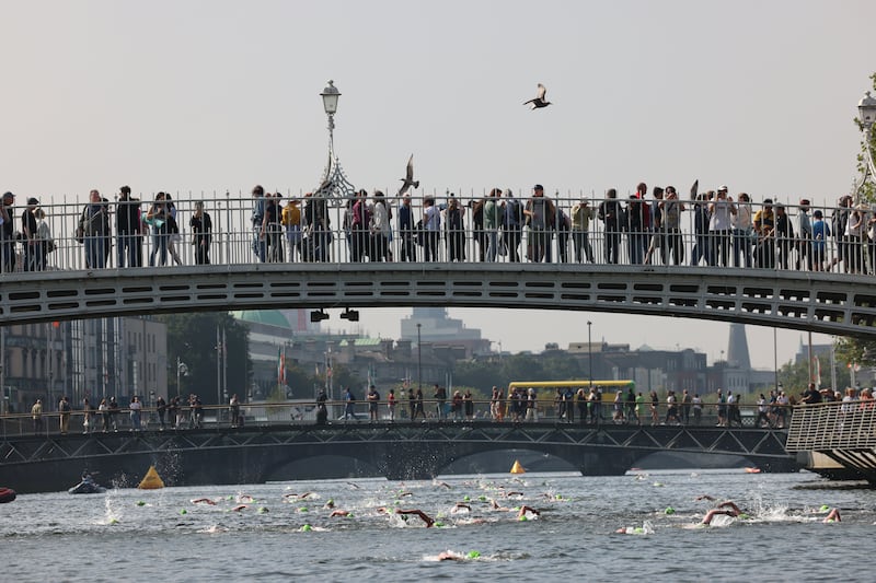Competitors and spectators at the Ha'penny Bridge stage of the women's event in the Liffey Swim. Photograph: Dara Mac Dónaill