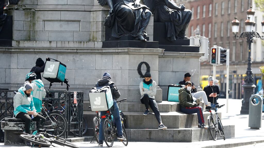Deliveroo workers  in Dublin city centre following the outbreak of  coronavirus. Photograph:  Reuters/Jason Cairnduff