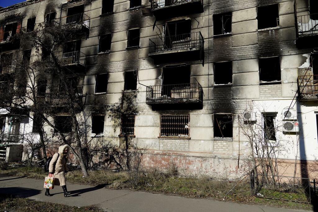 A woman walks past a destroyed apartment block in the Russian-controlled town of Severodonetsk in the eastern Lugansk region. Photograph: AFP via Getty Images