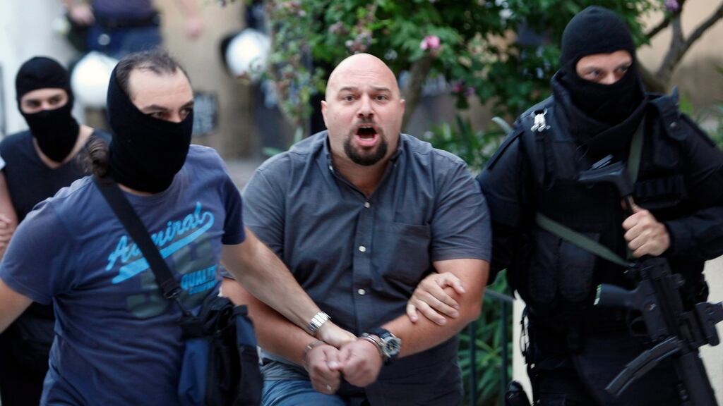 Extreme-right Golden Dawn party lawmaker Ilias Panagiotaros is escorted by anti-terrorism police officers as he arrives at a courthouse in Athens. Photograph: Giorgos Moutafis/Reuters