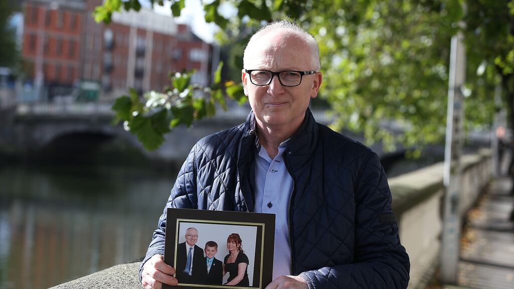 John Crossan of Lifford Co Donegal holds picture of son Luke and wife Sally who was left paralysed after road collision. Photograph: Collins Courts