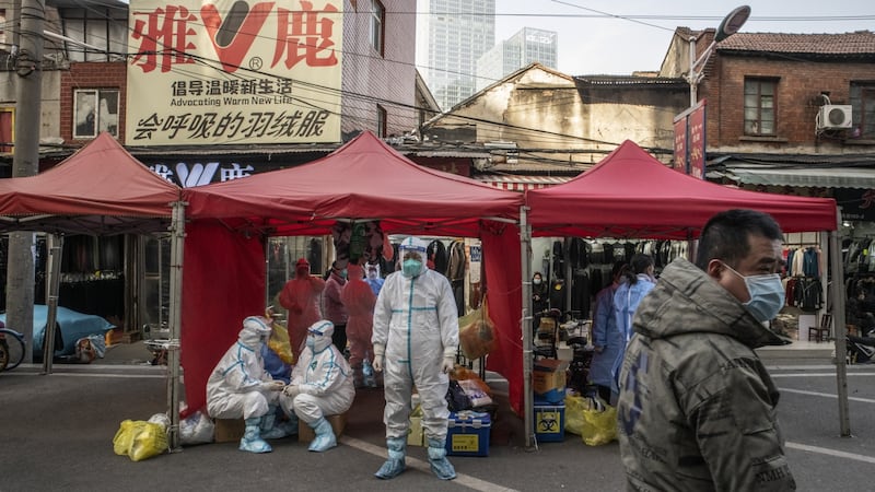 Contact tracers in hazmat suits on January 11th investigate a market where a Covid-positive traveller had visited merchants days earlier in Wuhan. Photograph: Gilles Sabrie/The NewYork Times