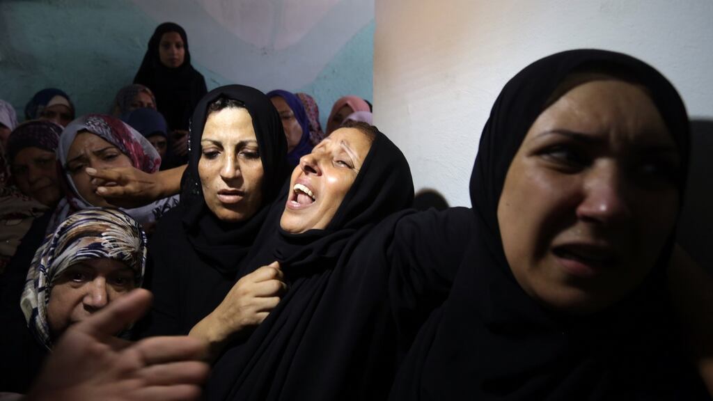 Relatives at the funeral of Noor Hassan (30) and her daughter Rahaf (2). Photograph: Mahmud Hams/AFP/Getty Images