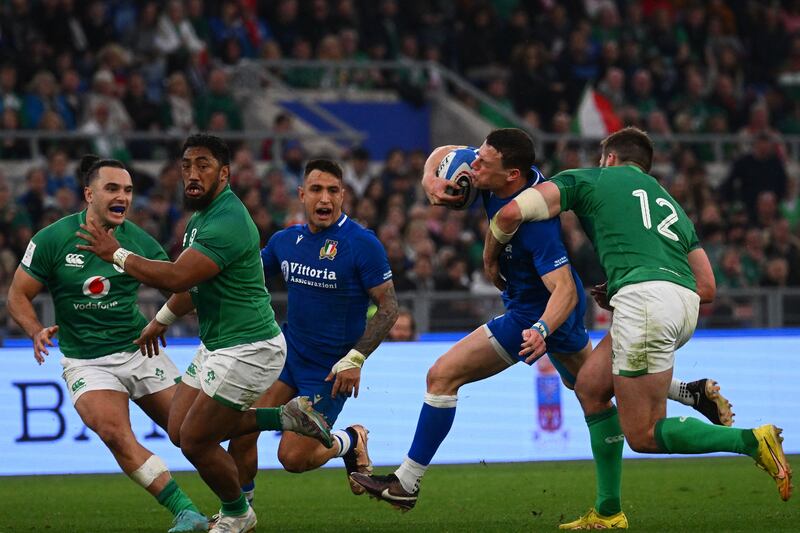 Italy' outhalf Paolo Garbisi is tackled by Ireland's Stuart McCloskey during the game at the Stadio Olimpico. Photograph: Vincenzo Pinto/AFP via Getty Images