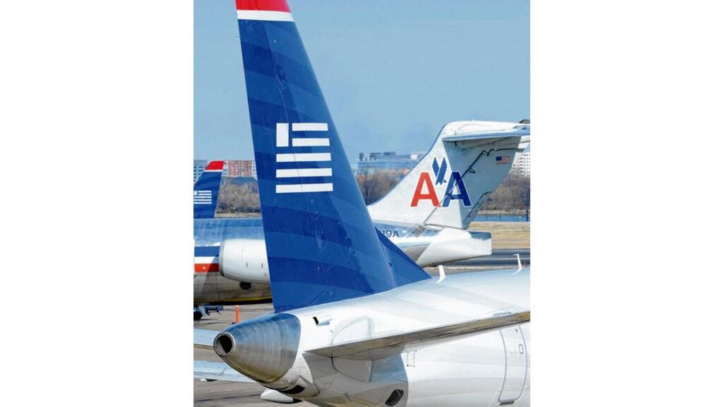 A US Airways plane taxis past an American Airlines plane at the Ronald Reagan Washington National Airport in Virginia. photograph: reuters