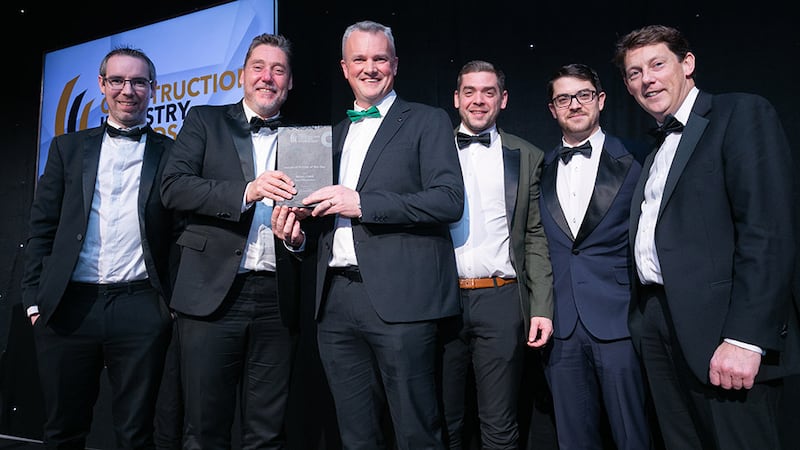 Darragh Coleman, managing director, William Cox, presents the Industrial Project of the Year award to Diarmuid Reil Architects team.