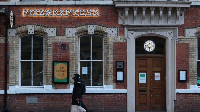 People walk past Pizza Express in Belfast this week during Northern Ireland’s  lockdown to curb  Covid-19. File photograph: Liam McBurney/PA Wire