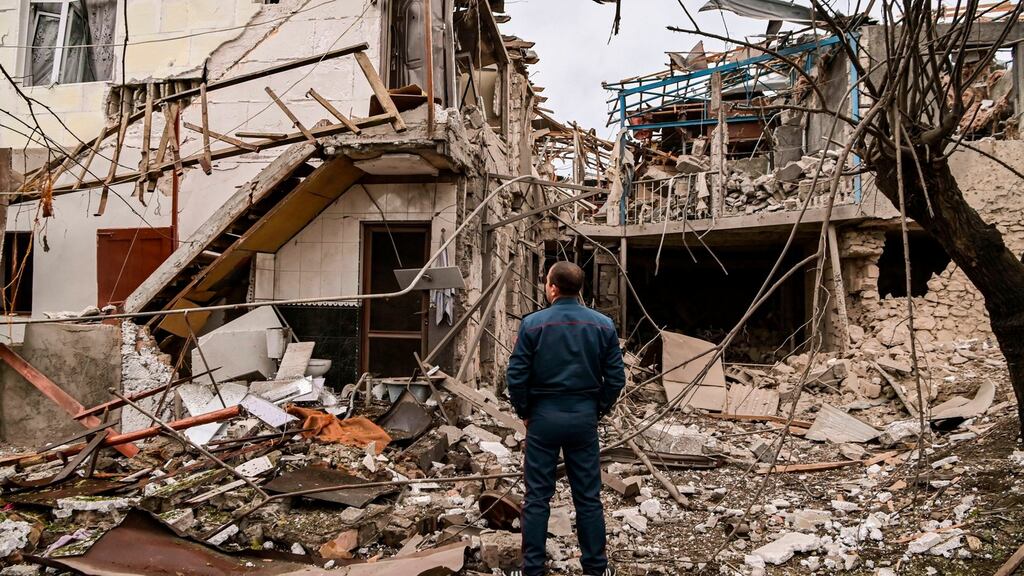 A police officer stands in front of a destroyed house after shelling in the breakaway Nagorno-Karabakh region’s main city of Stepanakert on October 7th, during the ongoing fighting between Armenia and Azerbaijan over the disputed region. Photograph: Aris Messinis/AFP via Getty