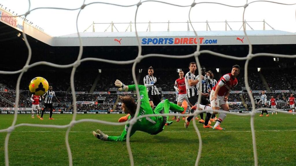 Arsenal’s Olivier Giroud heads home the only goal of the game to earn Arsenal a vital away win over Newcastle at St James’ Park. Photo: Nigel Rothers/Reuters