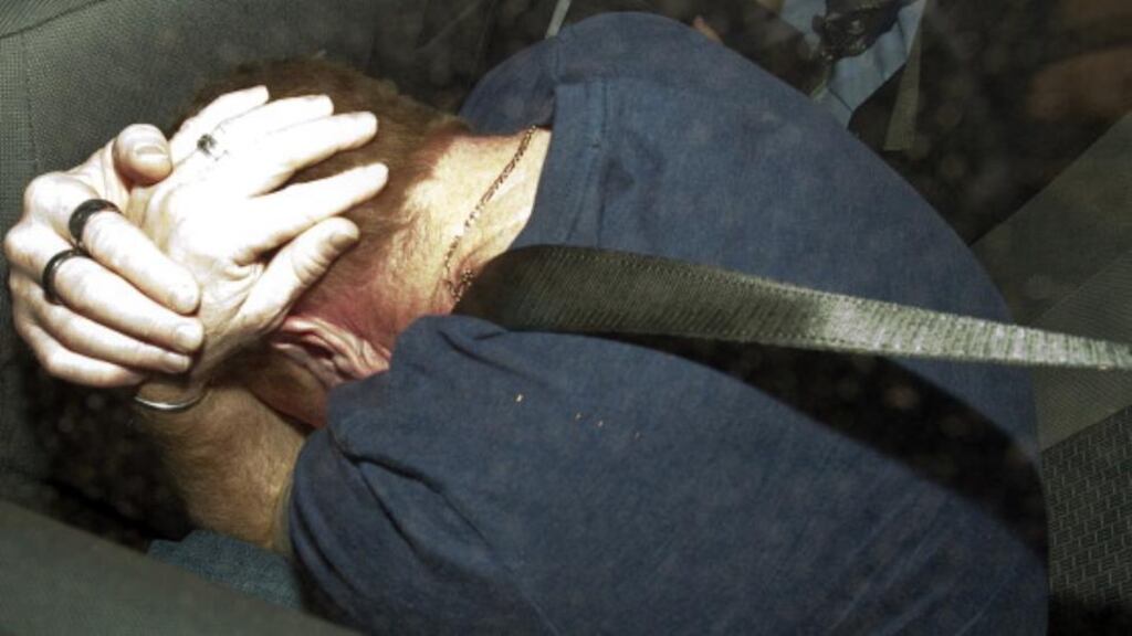 A file image of Adrian Bayley covering his face in a police car after being charged with the rape and murder of Jill Meagher, on September 28th, 2012. Photograph: Getty