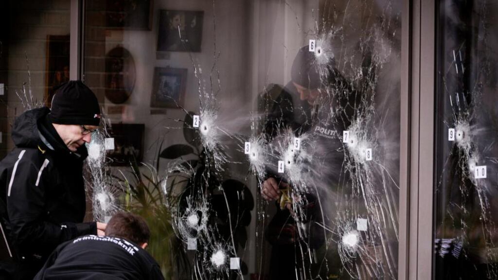 Police forensics inspect bullet holes in the door of Krudttoenden cafe where the terrorist attack started in Copenhagen. Photograph: LIselotte Sabroe/Denmark Out