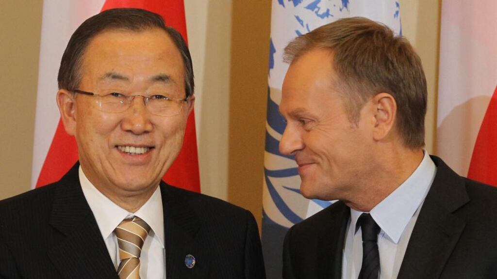 Polish Prime Minister Donald Tusk (R) and UN Secretary General Ban Ki-moon (L) pose for the media during a meeting in Warsaw, Poland