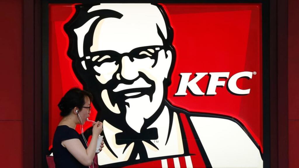 A customer walks past a KFC store in Shanghai yesterday. REUTERS/Aly Song