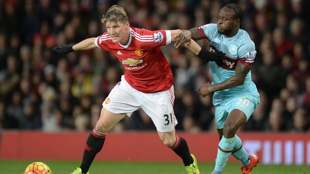 Manchester United’s German midfielder Bastian Schweinsteiger holds off Victor Moses against West Ham United. Photograph: Getty Images