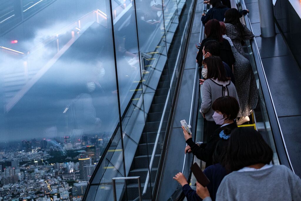 People take pictures on an escalator of Shibuya Sky observation deck, a tourist spot in Tokyo on May 30th. Photograph: Philip Fong/AFP via Getty Images