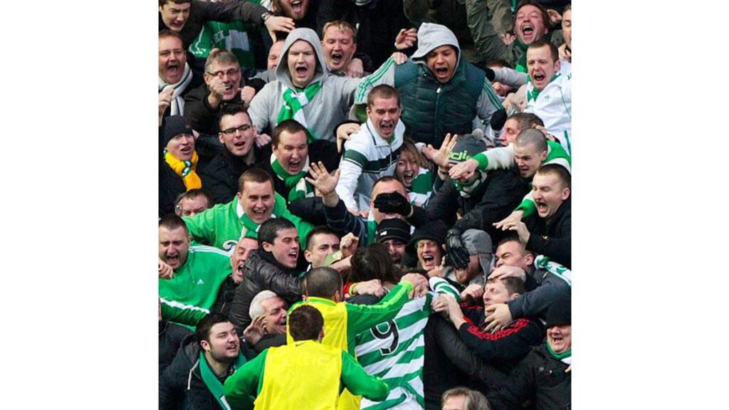 Celtic's Georgios Samaras (9) is surrounded by fans as he celebrates scoring his first goal against Rangers during their Scottish Premier League 'Old Firm' soccer match at Ibrox. - (Photograph: David Moir/Reuters)