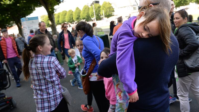 Maria Flemming Hand sleeps on her father Mark Hand’s shoulder at the Dublin Horse Show. Photograph: Dara Mac Dónaill