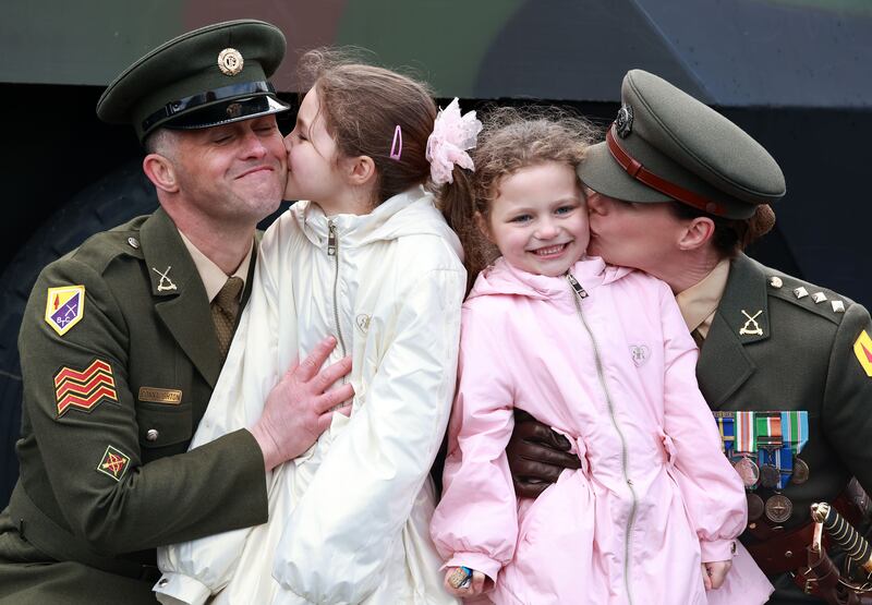 Husband and wife Sgt Dave Connaughton and Capt Kira Connaughton with their daughters, Molly (8) and Fiadh (6) after Capt Connaughton was commissioned at the Defence Forces ceremony at the Curragh on Friday. Photograph: Colin Keegan/Collins