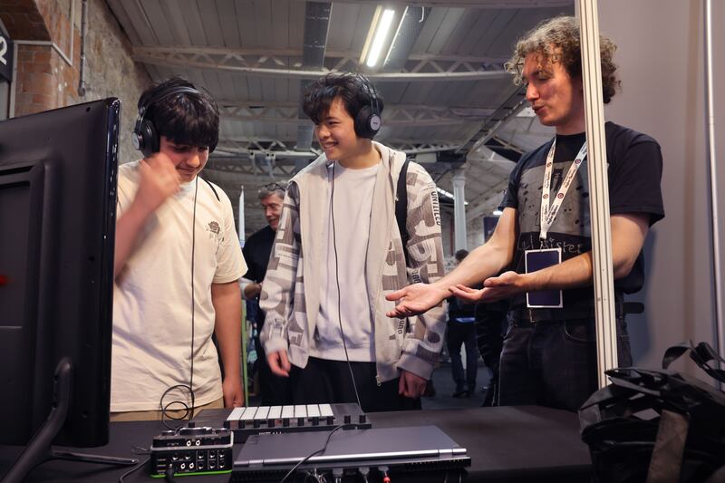Jolyous Esttaifan and Jac Zlong, from Selskor College, Wexford, at the BIMM Music Institute, stand with lecturer Dylan Ingram Roche, (right) at The Irish Times Higher Options in the RDS, Ballsbridge, Dublin. Photograph: Dara Mac Dónaill