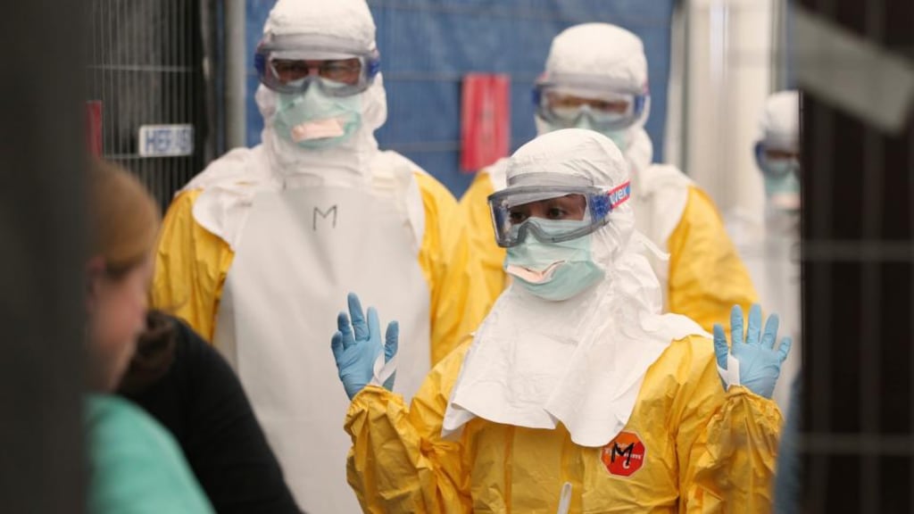 Volunteers with Médecins Sans Frontières in Brussels receive training on how to handle personal protective equipment. Photograph: Francois Lenoir/Reuters