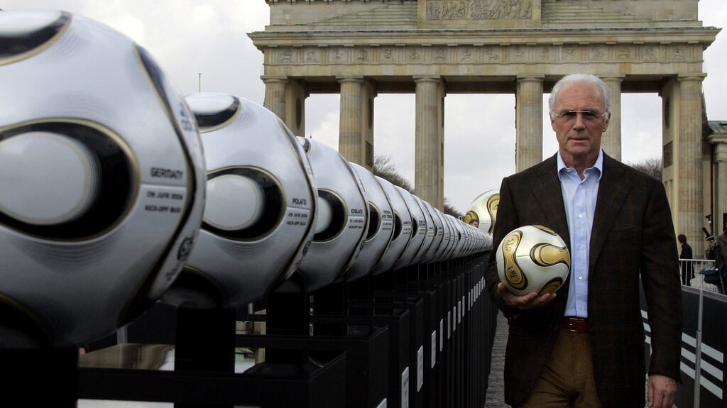 Franz Beckenbauer, then president of Germany’s World Cup organising committee, holds a golden soccer ball during a presentation at the Brandenburg Gate in Berlin in April 2006. Photograph: Tobias Schwarz/Reuters
