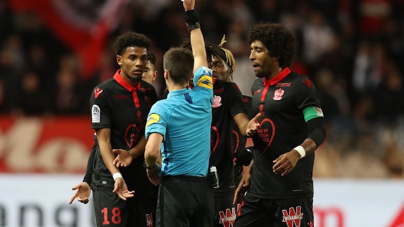 French referee Benoît Bastien gives a red card to Nice’s French forward Ihsan Sacko during the Ligue 1 match between Monaco and Nice at the Stade Louis II in Monaco. Photograph: Valery Hache/AFP/Getty Images