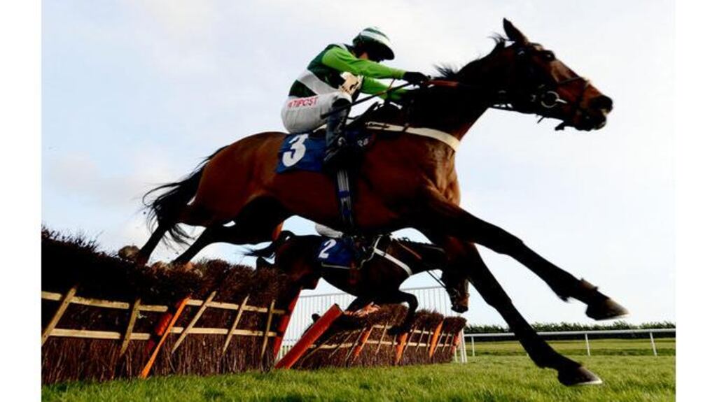 Darlan (Tony McCoy, far side), a leading contender for the Champion Hurdle, suffers a fatal fall in the Listed 32 Red Hurdle, overshadowing victory for reigning champion hurdler Rock On Ruby (foreground) in the hands of Noel Fehily. Photograph: John Giles/PA
