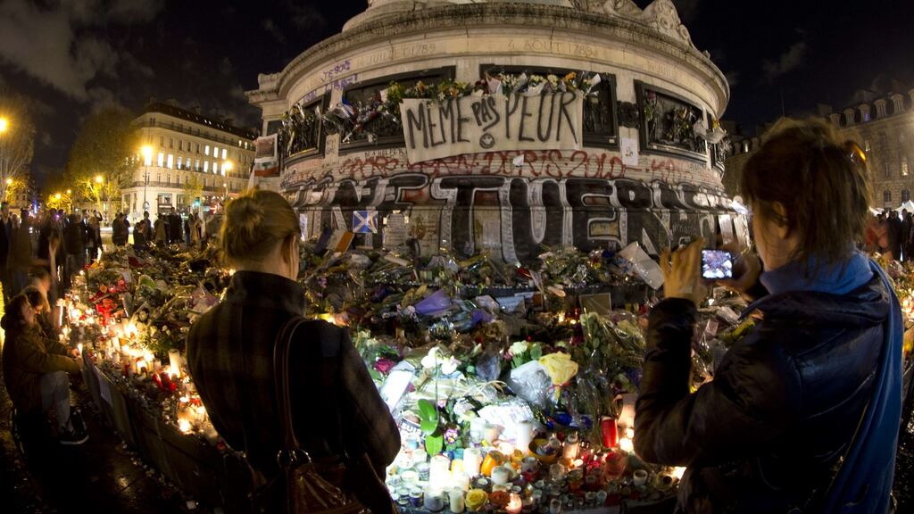 People gather around the Monument a la Republique at the Place de la Republique square in tribute to the victims. Photograph: AFP/Getty Images