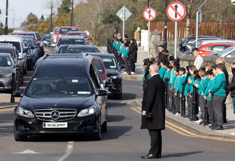 Schoolchildren form a guard of honour for Anthony Gallagher's funeral Mass. Photograph: Joe Dunne