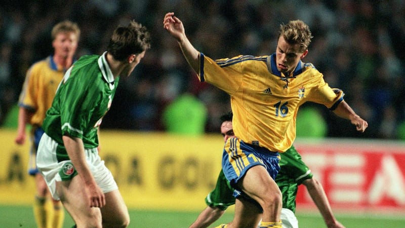 Niclas Alexandersson of Sweden is tackled by Alan McLoughlin (behind) and Kevin Kilbane. Photograph: Tom Honan/Inpho