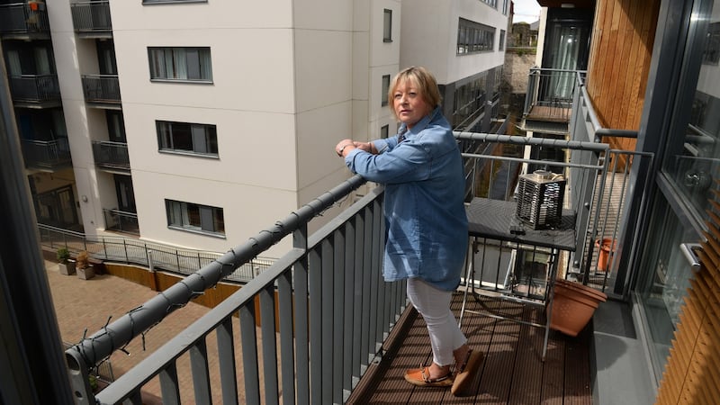 Gabrielle Kavanagh  on a balcony  at Cathedral Court, Dublin 8. Photograph: Dara Mac Dónaill/The Irish Times