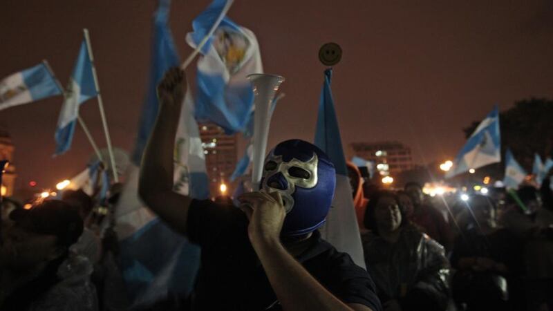 Citizens celebrate after the announcement of the loss of immunity of Guatemalan President Otto Pérez Molina. Photograph: Esteban Biba/EPA