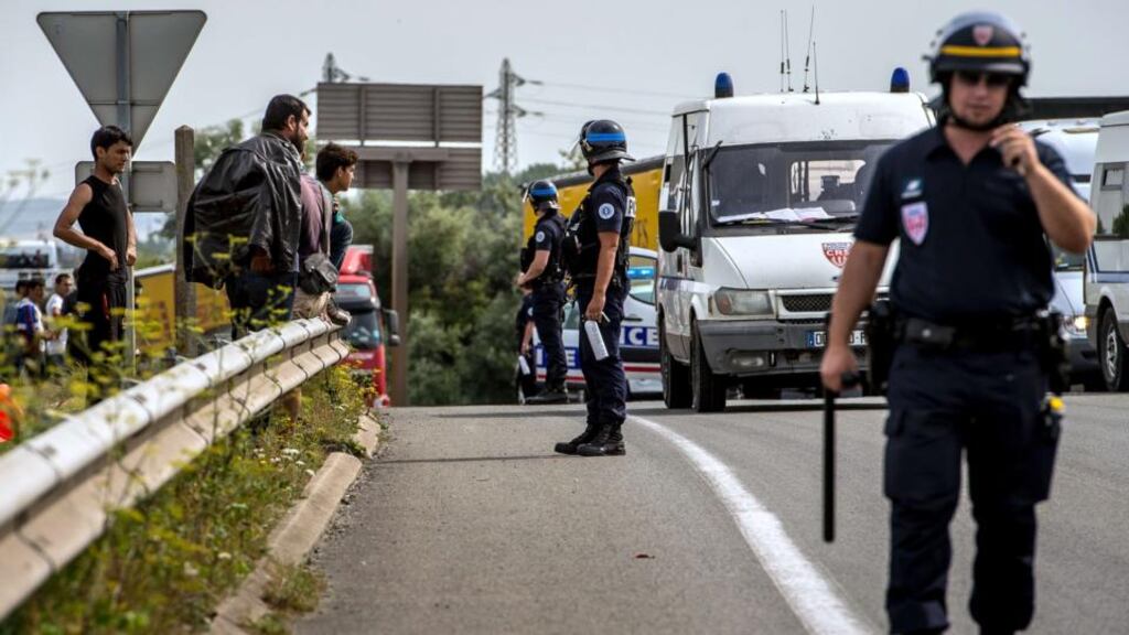 French riot police stand on a road to prevent migrants from reaching the road leading to the ferry port in Calais. Photograph: Philippe Huguen/AFP/Getty Images