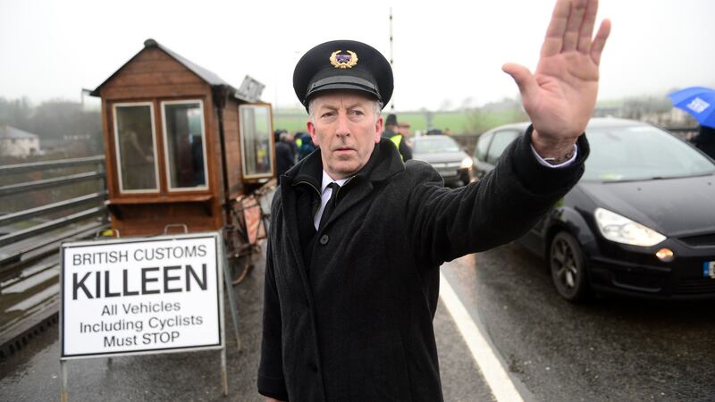 John McNamee, dressed as customs workers, joined other members of Border Communities Against Brexit earlier this year to protest against Brexit by setting up an old customs post at Carrickcarnon between Dundalk and Newry. Photograph: Dara Mac Dónaill / The Irish Times