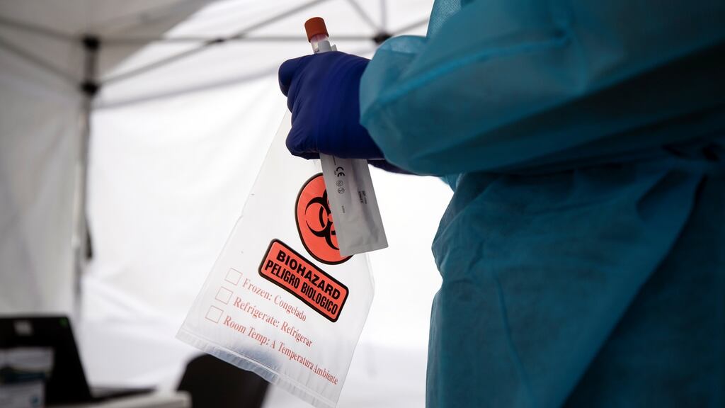 A doctor holds a Covid-19 test kit at a mobile coronavirus clinic in Los Angeles, California. Photograph: Etienne Laurent/EPA