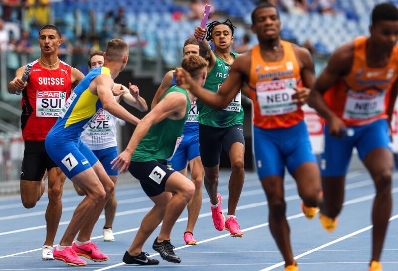 Ireland’s Seán Doggett hands over to Callum Baird. Photograph: Morgan Treacy/Inpho