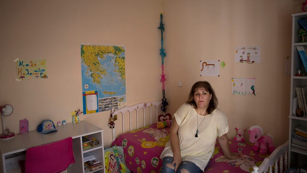 Georgia Pavlioti, who lost her job during the debt crisis, in her home in Athens. “We are just surviving, not living.” Photograph: Eirini Vourloumis/The New York Times