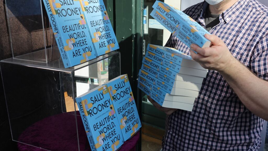 Window dresser Stephen Devlin with copies of Sally Rooney’s new book, Beautiful World, Where Are You, at Hodges Figgis, Dublin. Photograph: Dara Mac Dónaill