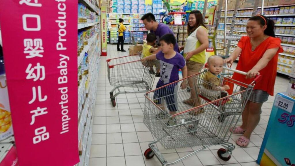 A family looks at foreign imported milk powder products at a supermarket in Beijing after China’s top economic planner decided to investigate leading foreign infant milk companies for suspected anti-trust violations. Photograph: Kim Kyung-Hoon/Reuters