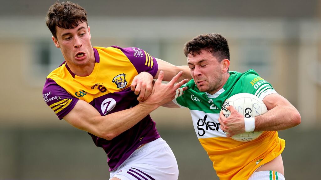 Wexford’s Glen Malone challenges Ruairí McNamee of Offaly during the Tailteann Cup preliminary round match at Bellefield GAA Complex in Enniscorthy. Photograph: Ryan Byrne/Inpho